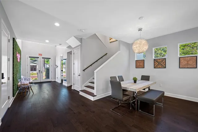 a living room with furniture a flat screen tv and a window