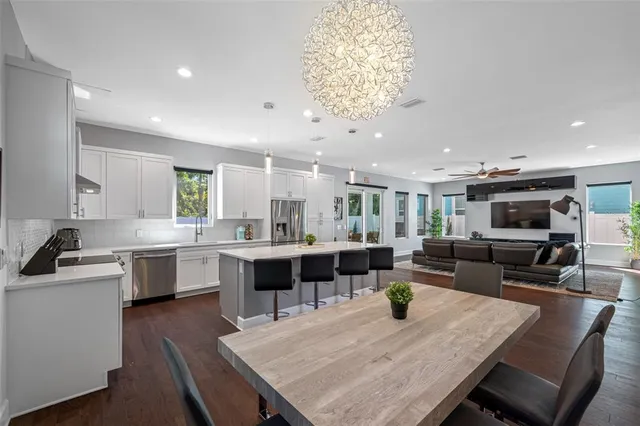 a living room with furniture a flat screen tv and a window