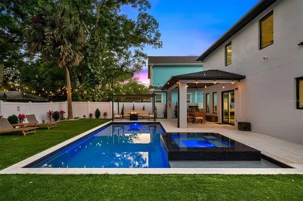 a view of a livingroom with furniture wooden floor and windows