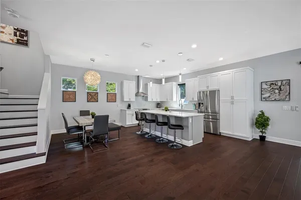 a spacious bedroom with a bed a couch and a potted plant