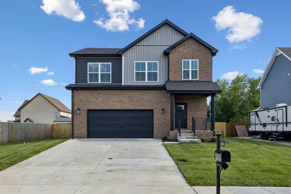 a front view of a house with a yard and garage
