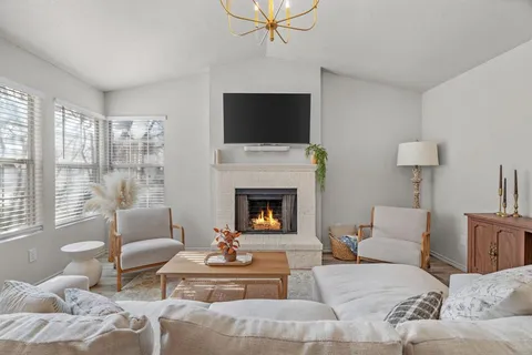 a living room with furniture and a chandelier