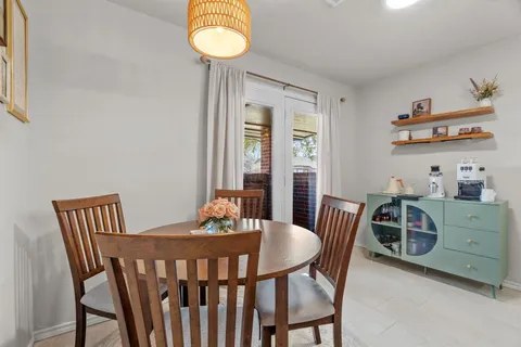 a view of kitchen with sink dining table and chairs