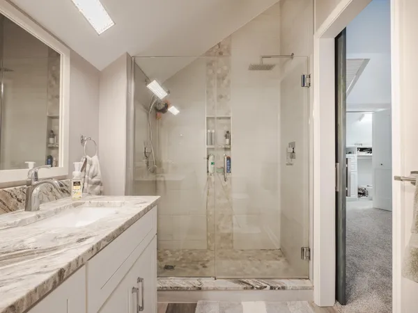 a view of storage and utility room with closet and window