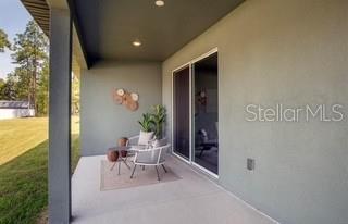 5900 Southwest 112th Pl Road Ocala, FL 34476 - Photo 11 of 17 a building outdoor space with patio furniture and potted plants