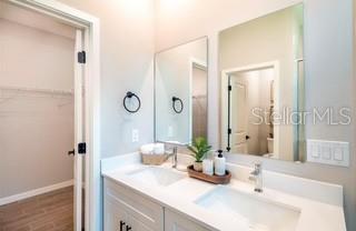 5900 Southwest 112th Pl Road Ocala, FL 34476 - Photo 9 of 17 a bathroom with a granite countertop sink and a mirror
