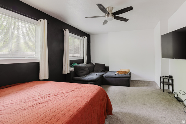 244 North 600 West Logan, UT 84321 - Photo 21 of 30 Carpeted room featuring a ceiling fan with integrated lighting, two windows with blinds, and white trim
