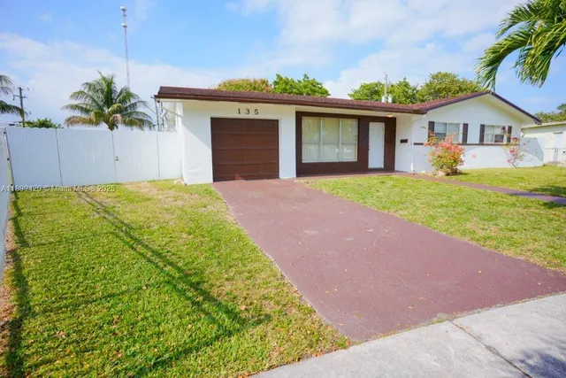 a front view of house with yard and outdoor seating