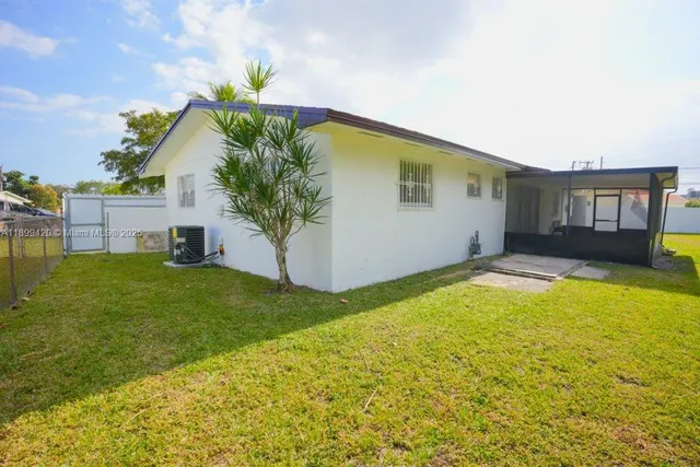 a front view of house with yard and trees