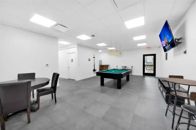 a room with furniture and pool table
