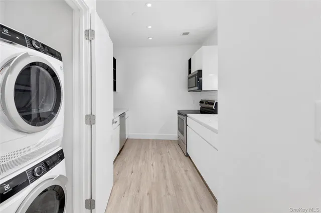 a view of a kitchen with washer and dryer