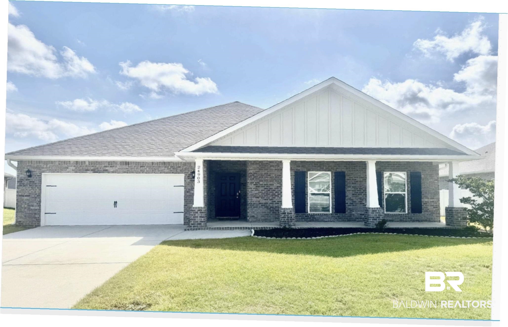24903 Spectacular Bid Loop Daphne, AL 36526 - Photo 1 of 37 Craftsman house with board and batten siding, a porch, brick siding, and a front lawn