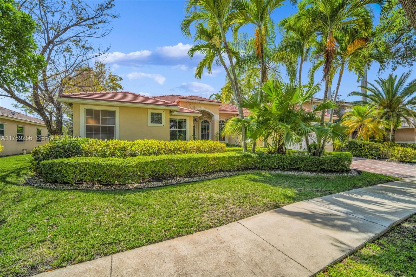 3739 Oak Ridge Circle Weston, FL 33331 - Photo 11 of 71 a front view of a house with a garden