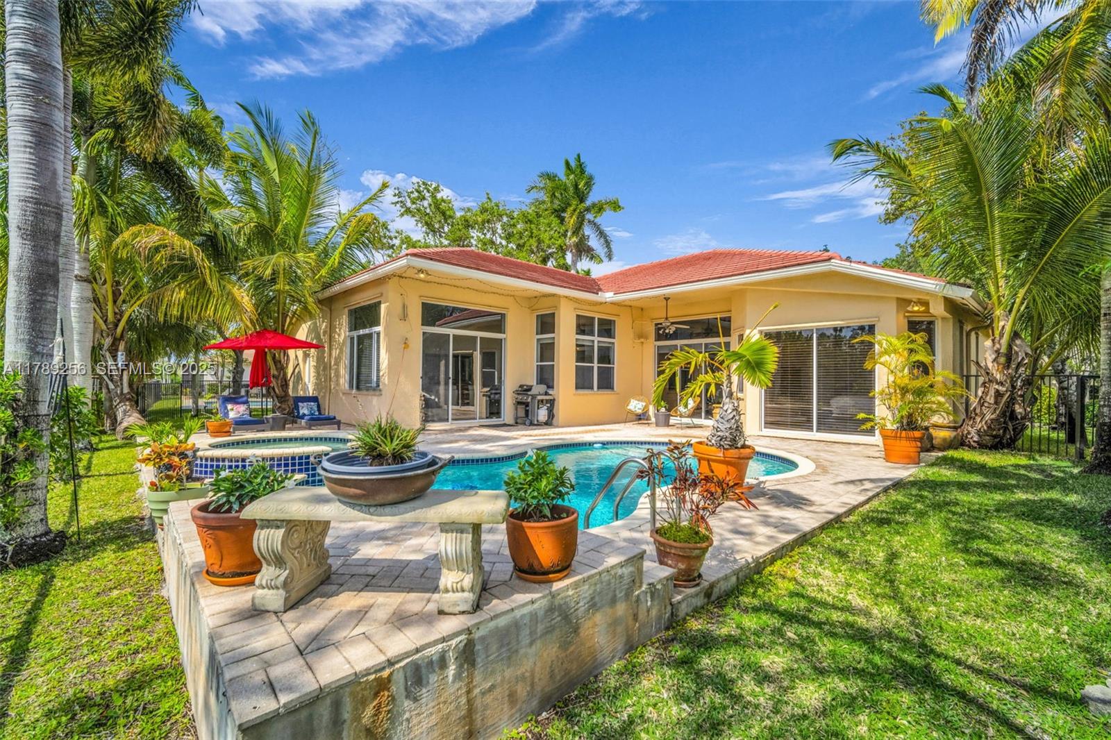 3739 Oak Ridge Circle Weston, FL 33331 - Photo 20 of 71 a view of a house with backyard sitting area and swimming pool