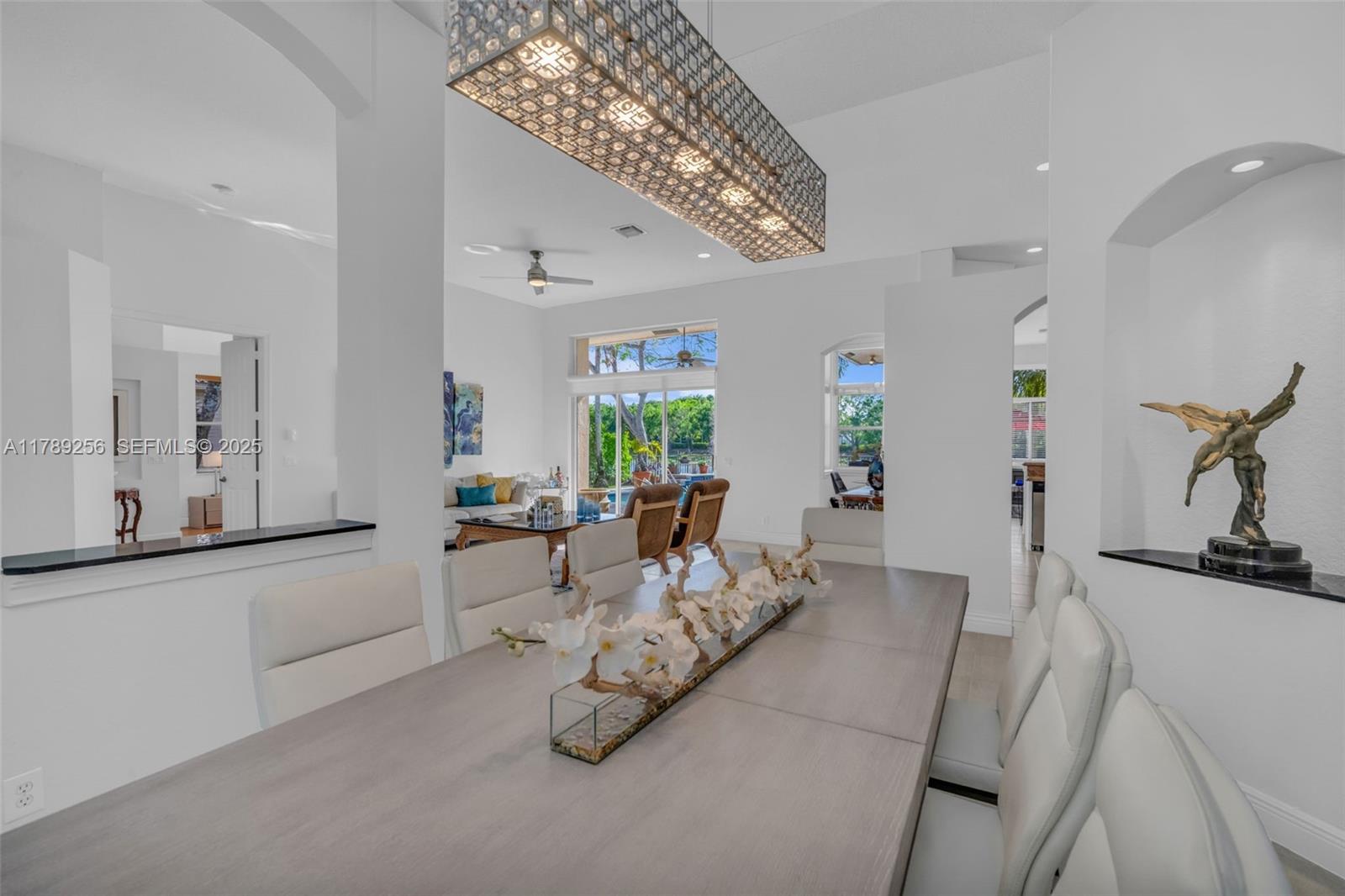 3739 Oak Ridge Circle Weston, FL 33331 - Photo 30 of 71 a living room with furniture and a chandelier