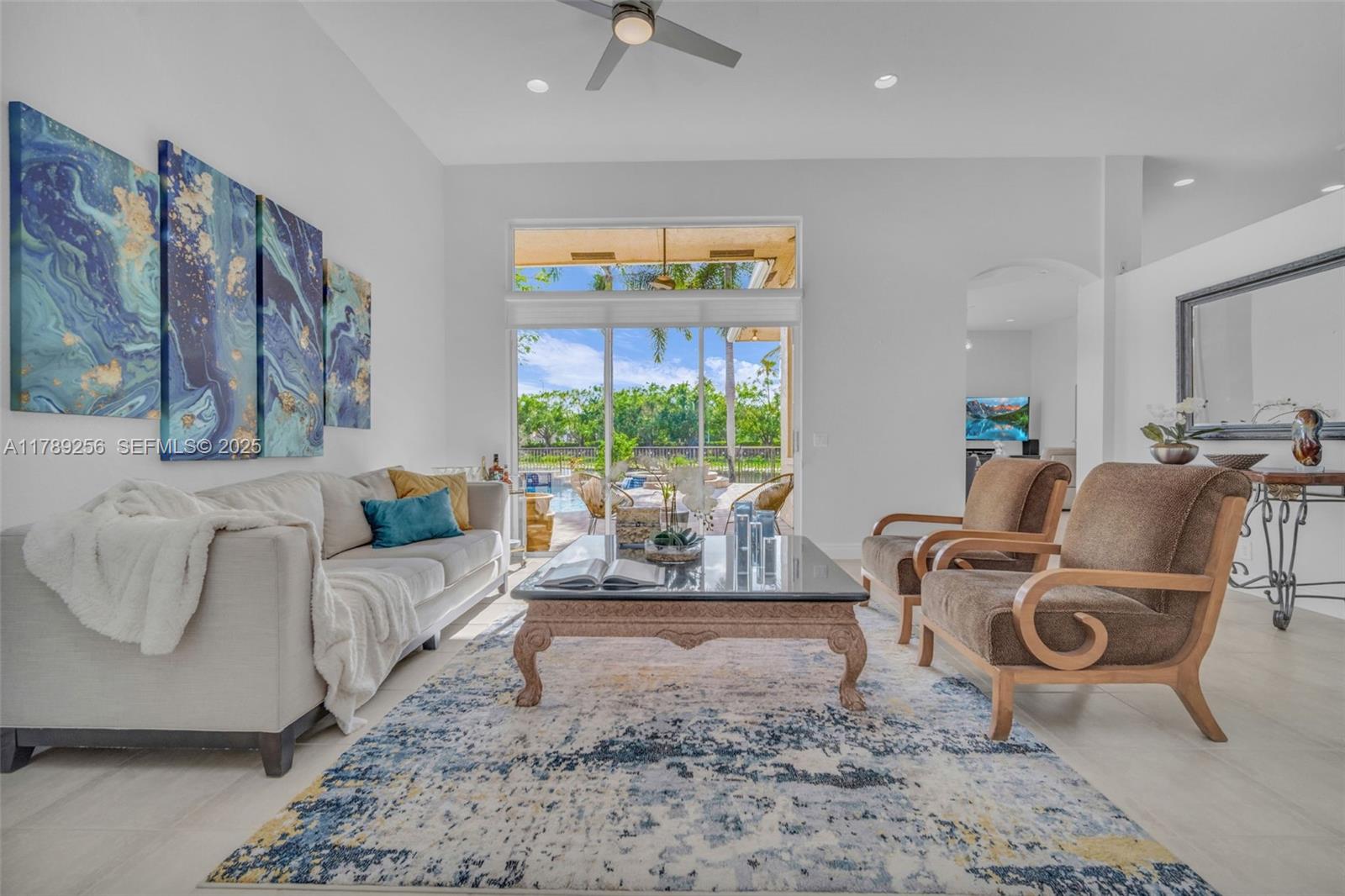 3739 Oak Ridge Circle Weston, FL 33331 - Photo 32 of 71 a living room with furniture a window and a flat screen tv