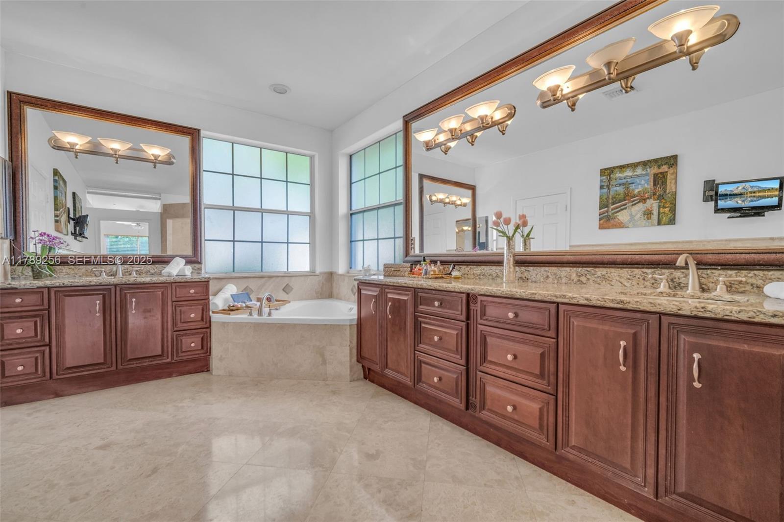 3739 Oak Ridge Circle Weston, FL 33331 - Photo 36 of 71 a spacious bathroom with a granite countertop double vanity sink a mirror and a bathtub