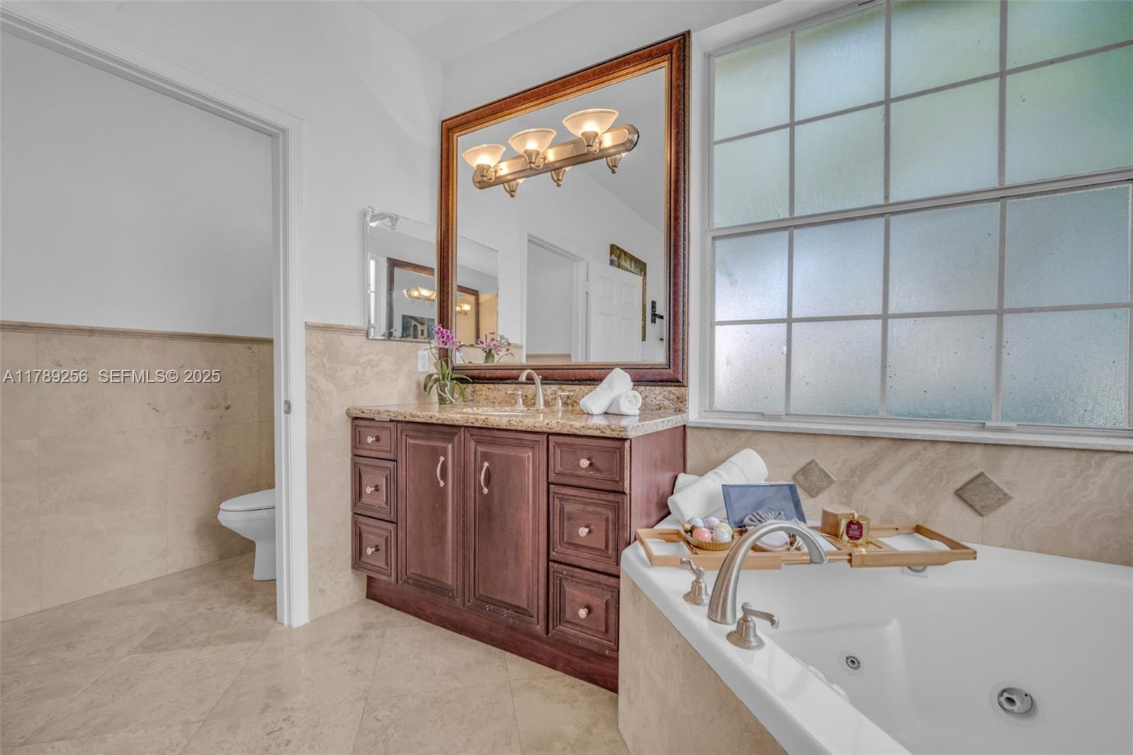 3739 Oak Ridge Circle Weston, FL 33331 - Photo 38 of 71 a bathroom with a sink and a mirror