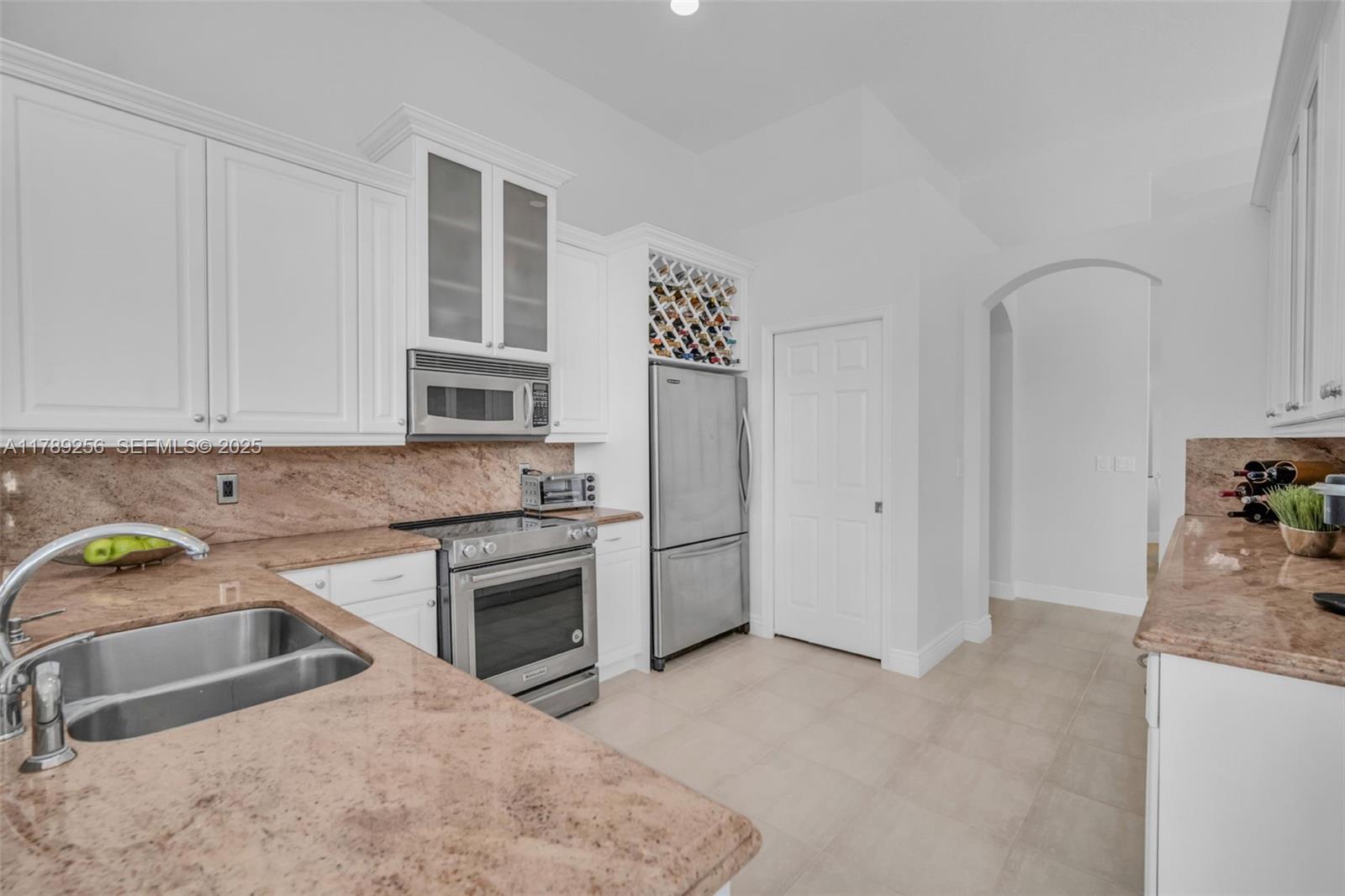 3739 Oak Ridge Circle Weston, FL 33331 - Photo 41 of 71 a kitchen with granite countertop a sink stainless steel appliances and cabinets