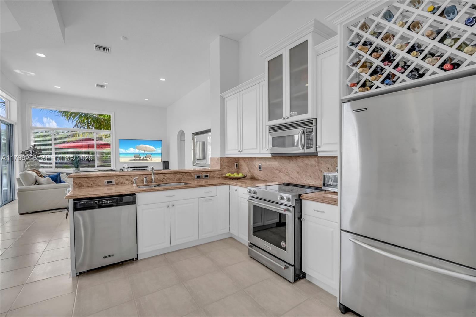 3739 Oak Ridge Circle Weston, FL 33331 - Photo 44 of 71 a kitchen with stainless steel appliances granite countertop a stove a sink and a refrigerator