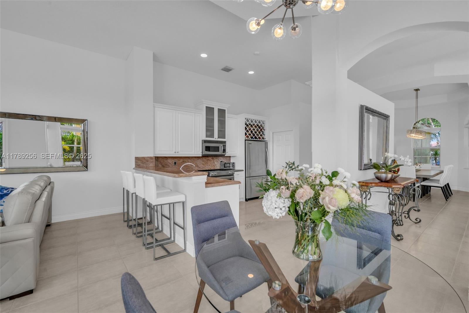 3739 Oak Ridge Circle Weston, FL 33331 - Photo 45 of 71 a living room with furniture potted plant and kitchen view