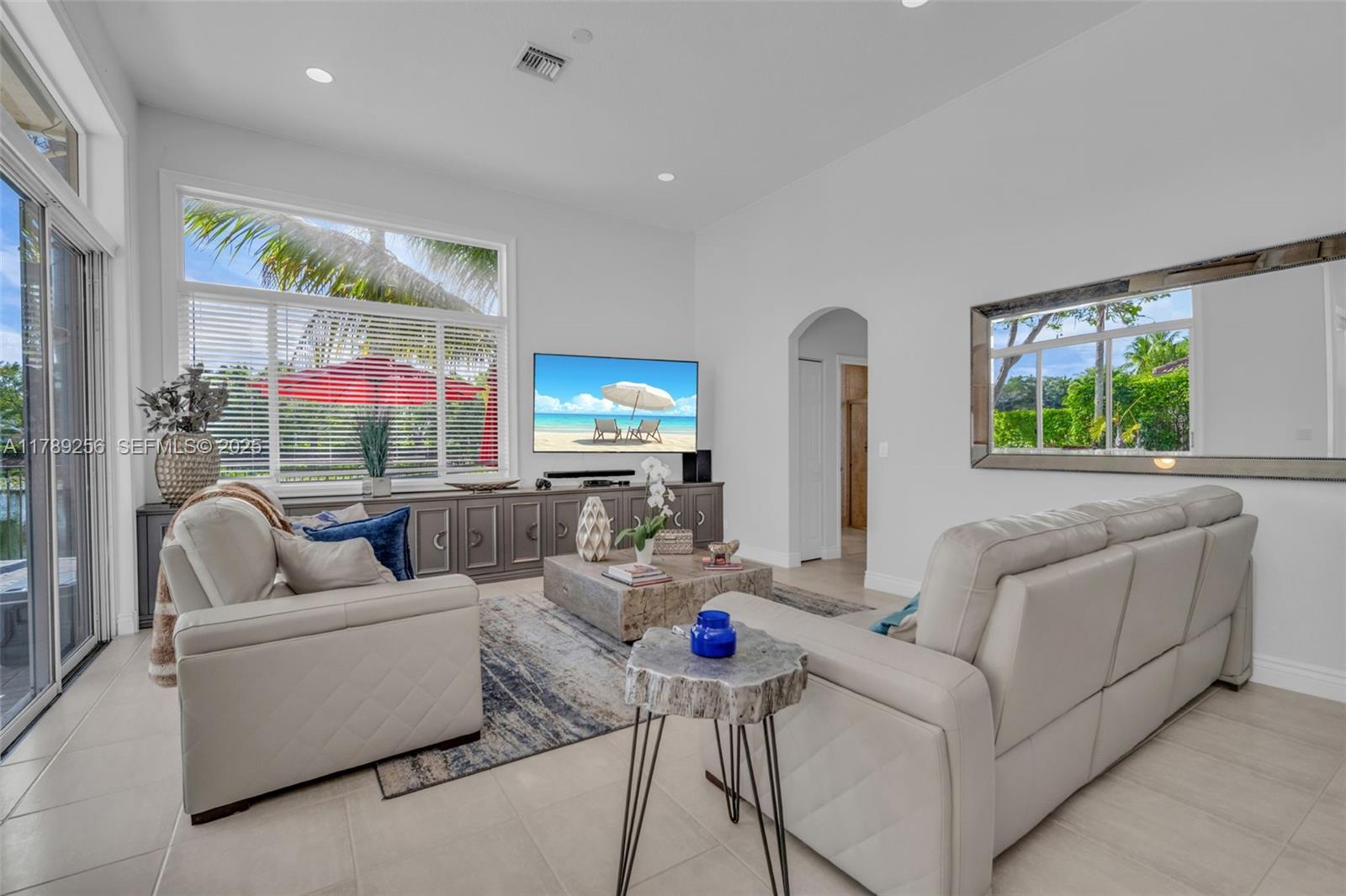 3739 Oak Ridge Circle Weston, FL 33331 - Photo 46 of 71 a living room with furniture kitchen view and a large window