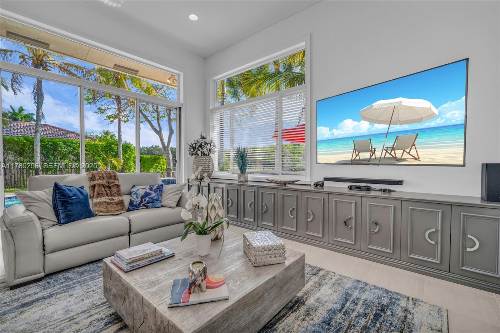 3739 Oak Ridge Circle Weston, FL 33331 - Photo 49 of 71 a living room with furniture a large window and a dining table