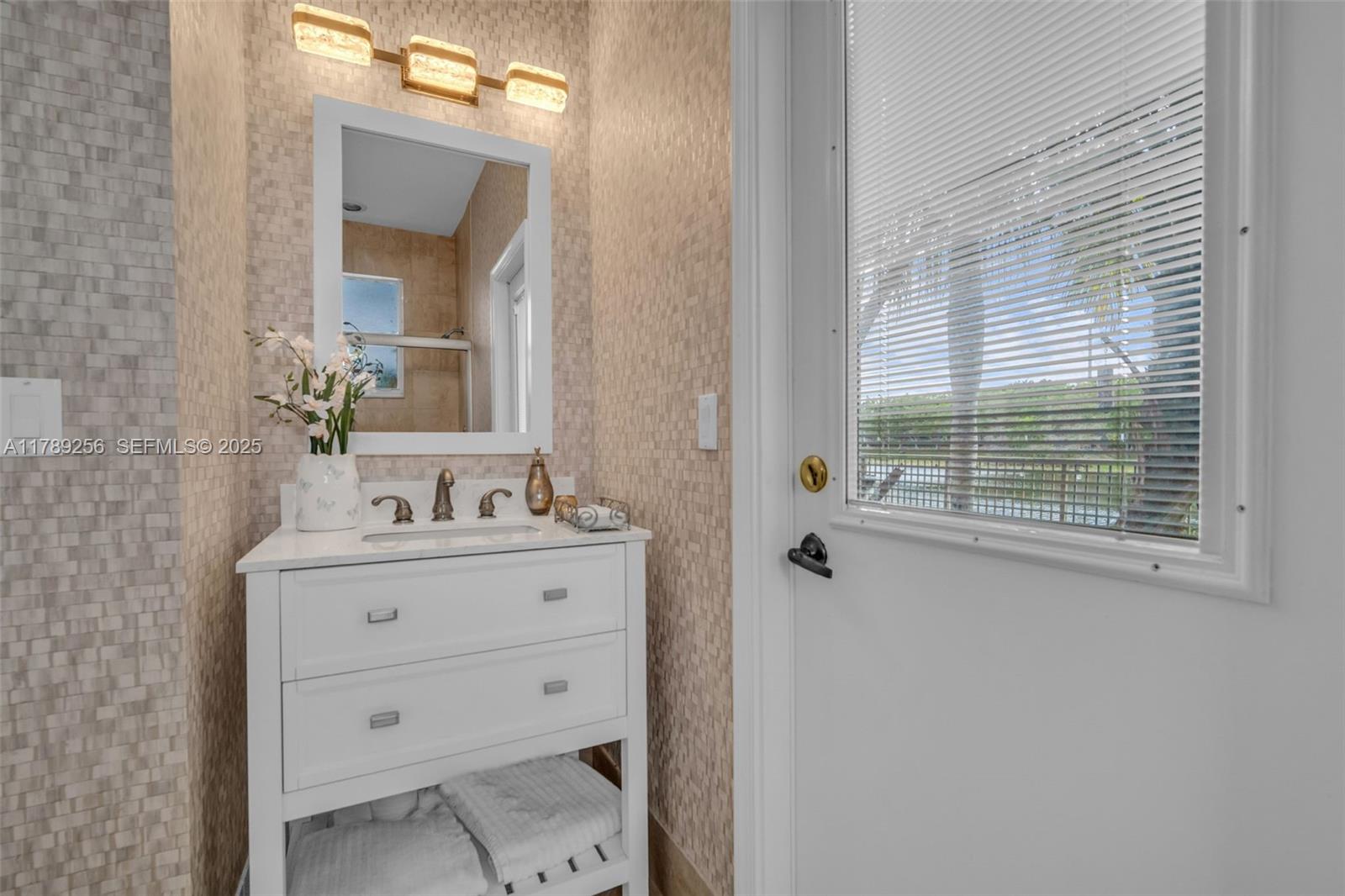 3739 Oak Ridge Circle Weston, FL 33331 - Photo 51 of 71 a bathroom with a sink vanity and mirror