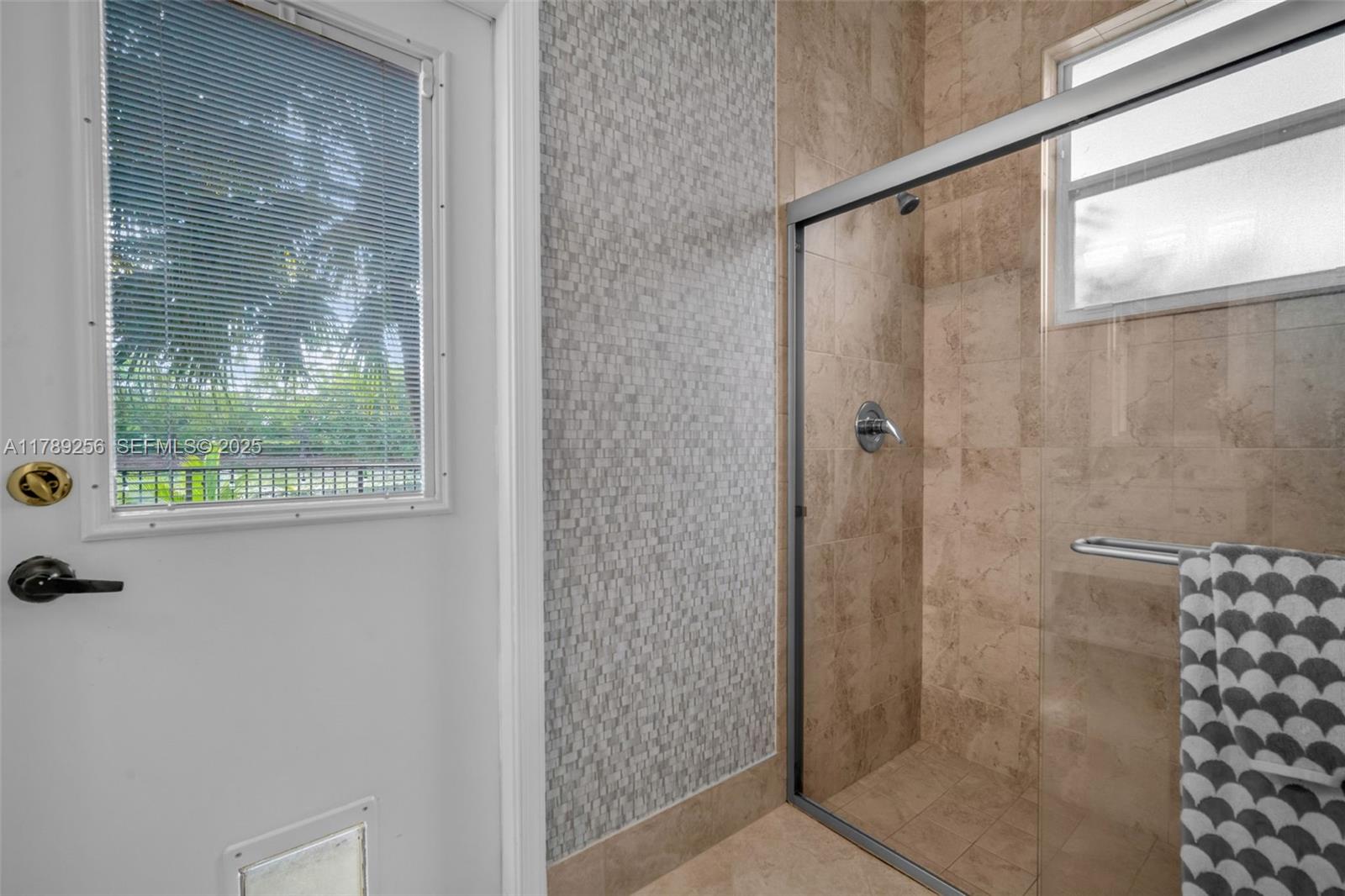 3739 Oak Ridge Circle Weston, FL 33331 - Photo 52 of 71 a bathroom with a glass shower door