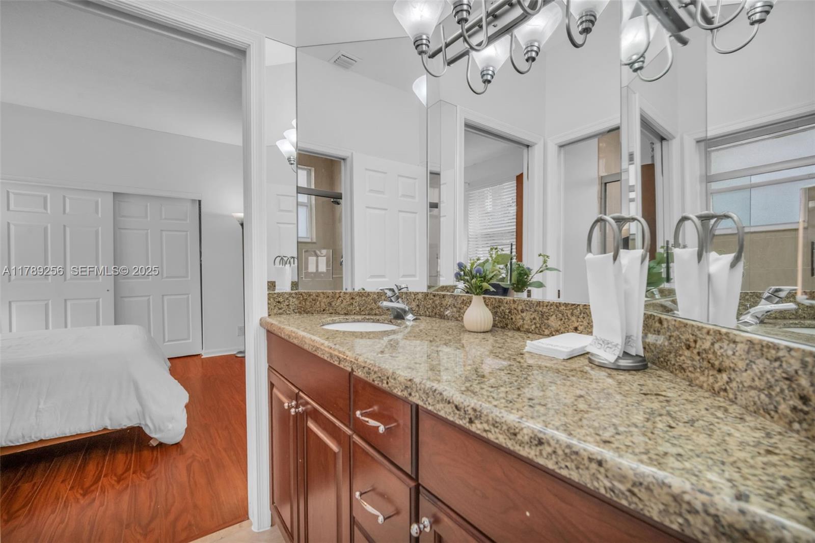 3739 Oak Ridge Circle Weston, FL 33331 - Photo 53 of 71 a bathroom with a granite countertop sink a mirror and shower