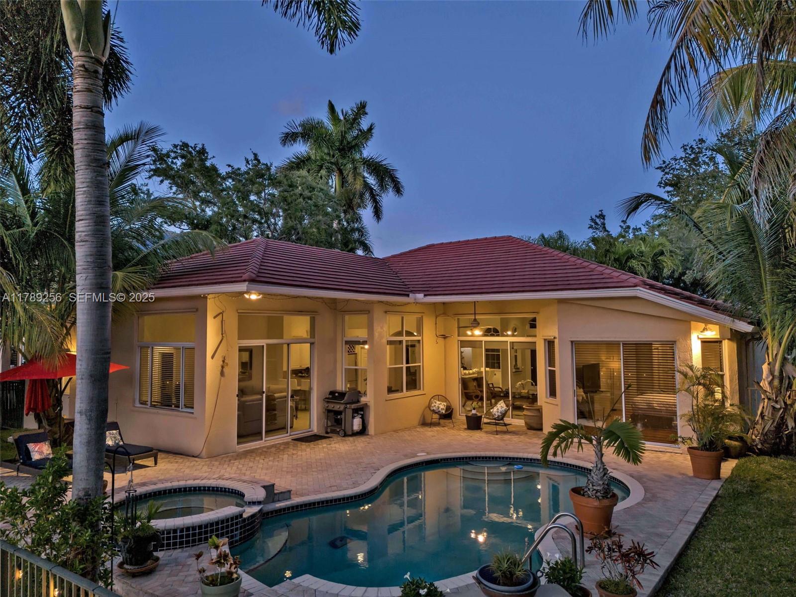 3739 Oak Ridge Circle Weston, FL 33331 - Photo 62 of 71 a front view of a house with swimming pool and porch