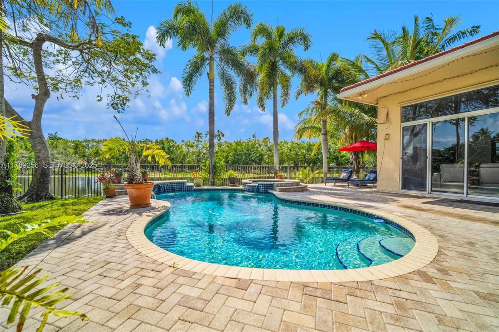 3739 Oak Ridge Circle Weston, FL 33331 - Photo 64 of 71 a view of a swimming pool with a sitting space