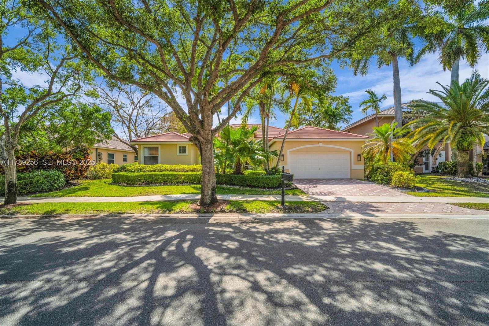 3739 Oak Ridge Circle Weston, FL 33331 - Photo 10 of 71 a view of a house with a yard and palm trees