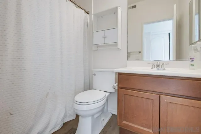 a bathroom with a sink toilet and vanity