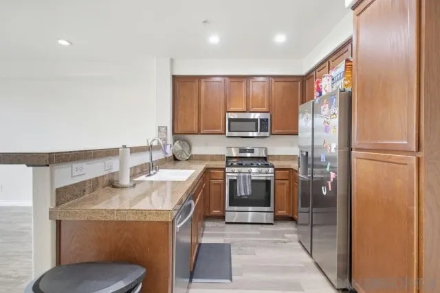 a kitchen with a sink appliances and cabinets