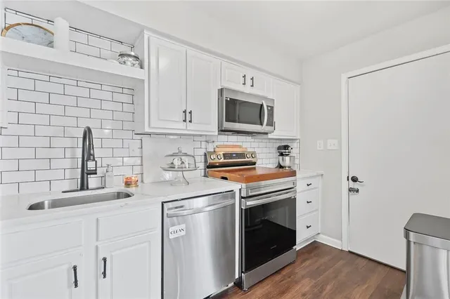 a kitchen with a sink stove and microwave
