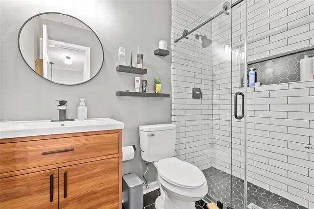 a bathroom with a toilet a sink and mirror