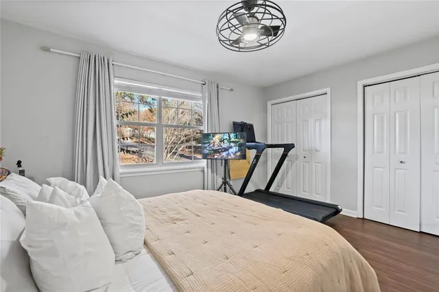 a bed sitting in a bedroom next to a window