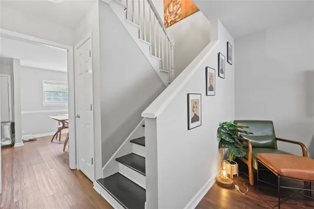 a view of entryway and hall with wooden floor