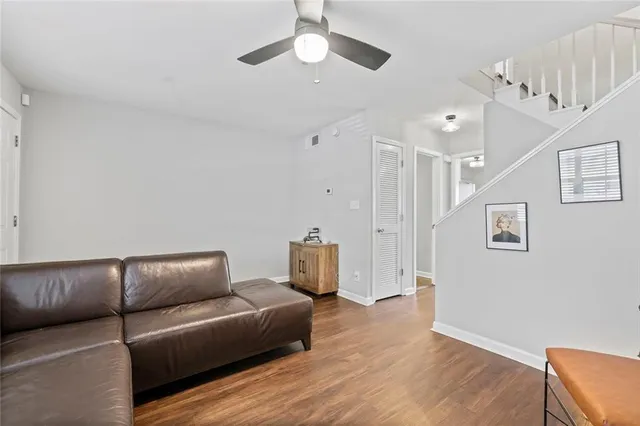 a living room with furniture and a wooden floor