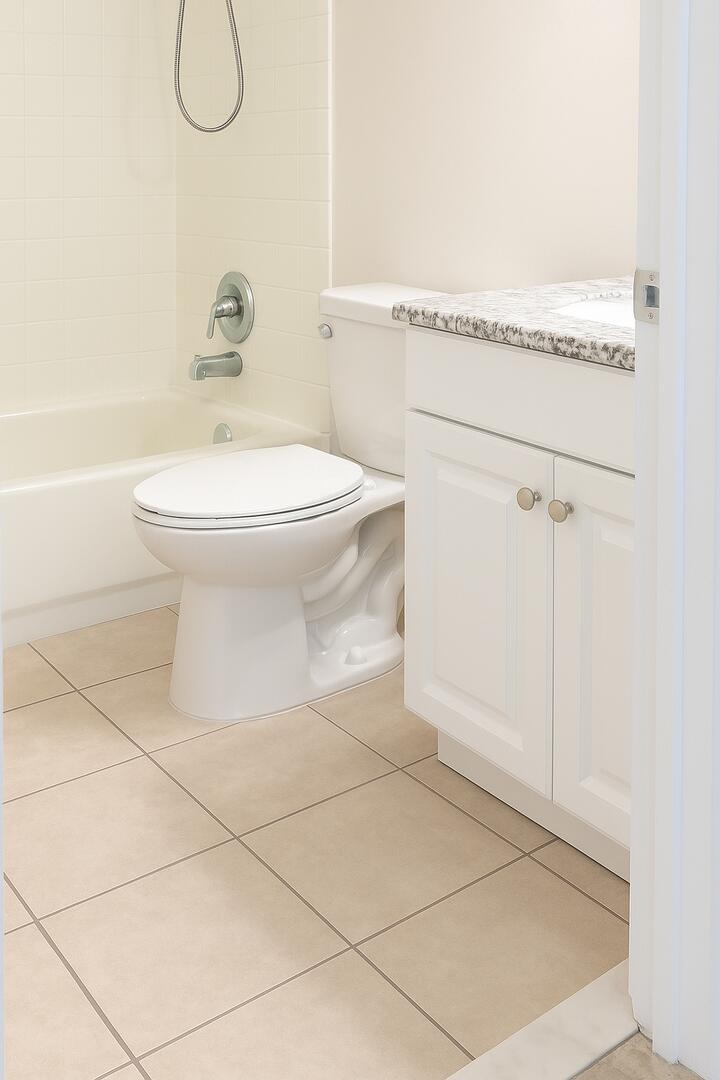 4670 Northeast 5th Avenue, Unit 1 Boca Raton, FL 33431 - Photo 4 of 8 a bathroom with a toilet and a shower