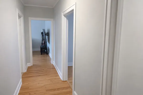 a view of a hallway with wooden floor