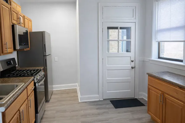 a kitchen with a refrigerator stove and sink