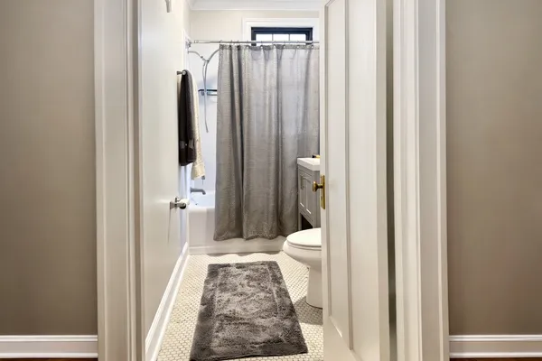 a bathroom with a toilet and a shower