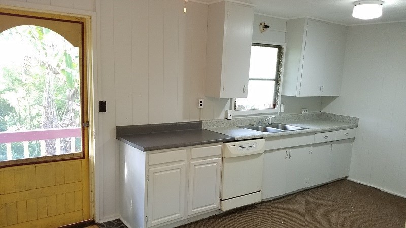 4940 Awawa Road Hanapepe, HI 96705 - Photo 9 of 22 a kitchen with a sink window and cabinets