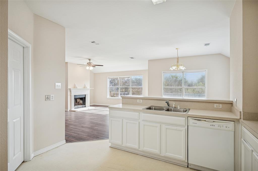 407 Autry Boulevard Gunter, TX 75058 - Photo 13 of 28 a kitchen with white cabinets and window