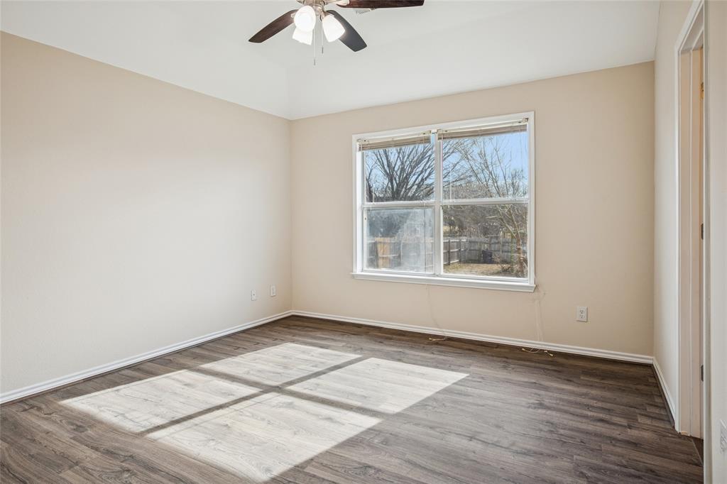 407 Autry Boulevard Gunter, TX 75058 - Photo 15 of 28 an empty room with wooden floor and windows