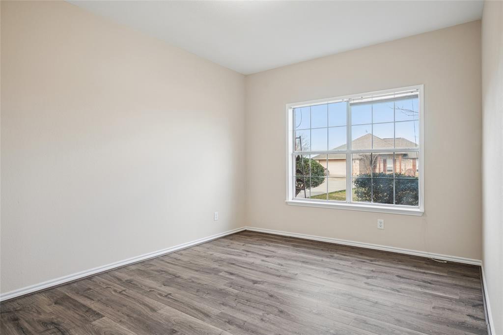 407 Autry Boulevard Gunter, TX 75058 - Photo 18 of 28 an empty room with wooden floor and windows