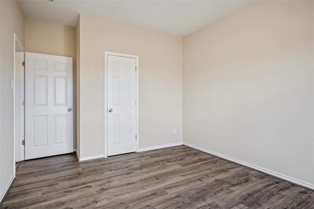 407 Autry Boulevard Gunter, TX 75058 - Photo 19 of 28 a view of a room with wooden floor and white doors