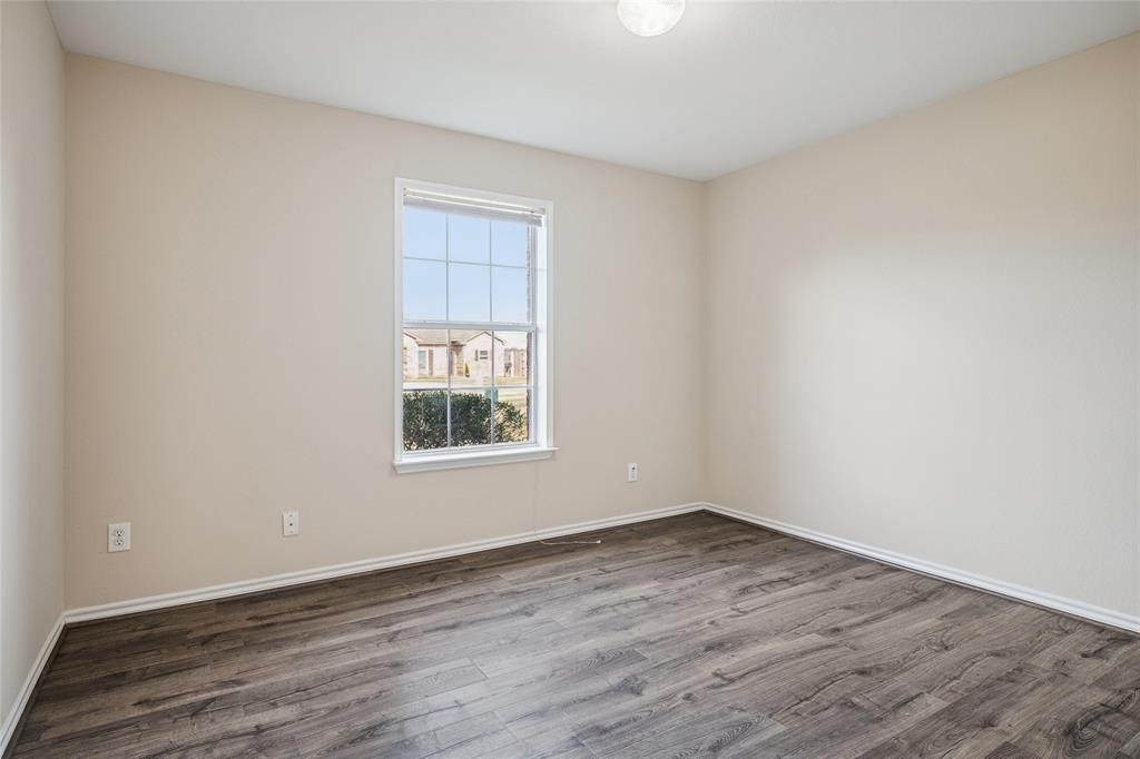 407 Autry Boulevard Gunter, TX 75058 - Photo 20 of 28 wooden floor in an empty room with a window